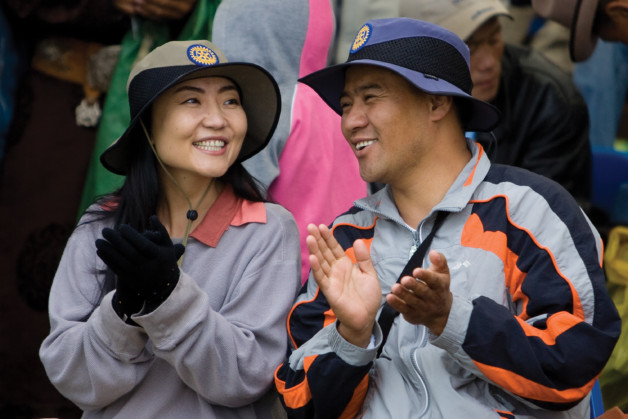 Uyanga Tsakhilgaan (left), of the Rotary Club of Niislel, Ulaanbaatar, Mongolia, and Ganbat Erdene, of the Rotary Club of Tuul, Ulaanbaatar, Mongolia, watch the Naadam festival in Kharkhorin, Mongolia, which is one of the sites for Keep Mongolia Green. Keep Mongolia Green is a five-year project undertaken by Korean and Mongolian Rotarians to counter desertification and erosion caused by in part by overgrazing of livestock in Mongolia. To date, it has planted more than 250,000 trees, built infrastructure, and provided training for local farmers. Funding was provided by multiple Matching Grants from The Rotary Foundation. 10 July 2008. Find the story in "The Rotarian," October 2008, pages 52-57.